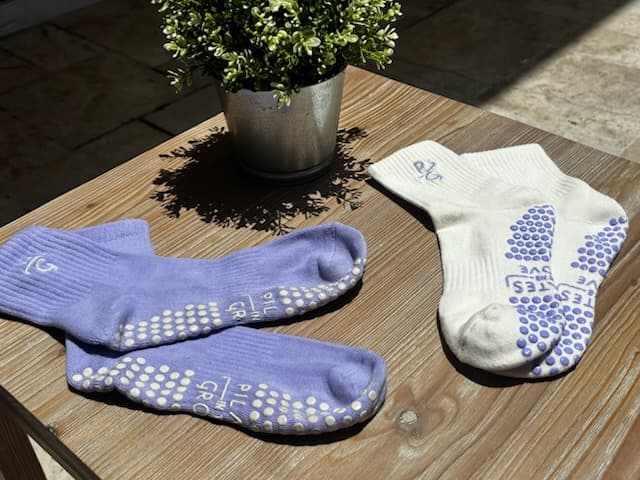 Branded purple and white grip socks from Pilates in the Grove